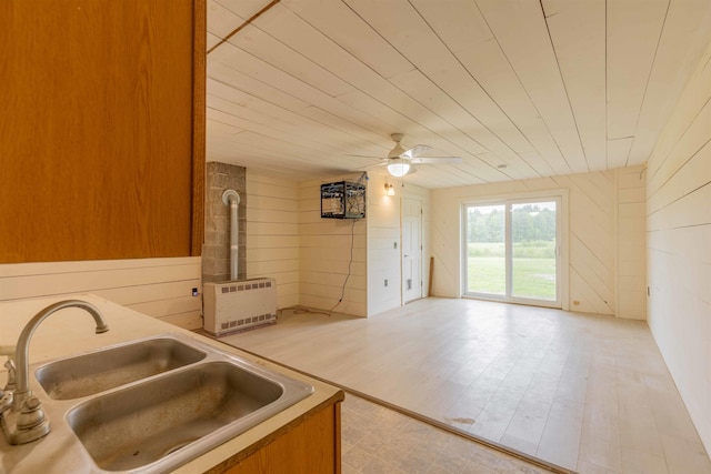 122 Flagg Rd, Rochester, NH 03839 - kitchen featuring a sink, wooden walls, ceiling fan, wooden ceiling, and heating unit