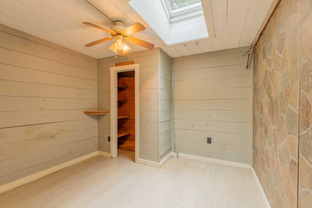 122 Flagg Rd, Rochester, NH 03839 - empty room featuring a skylight, wood walls, wood finished floors, wood ceiling, and a ceiling fan