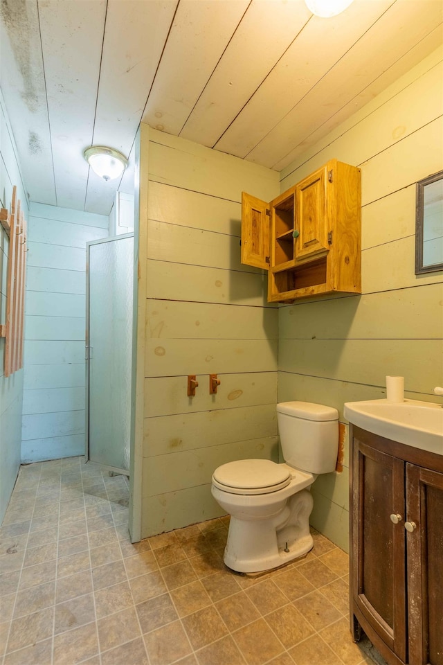 122 Flagg Rd, Rochester, NH 03839 - full bathroom with wooden walls, toilet, vanity, and a walk in shower