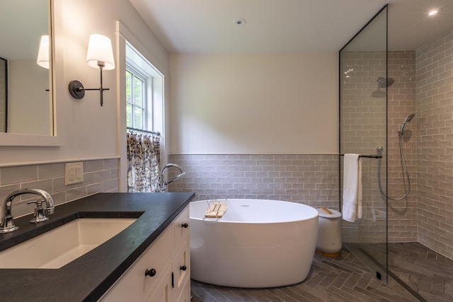 1640 Three Maple Dr, Manchester, VT 05255 - bathroom with tile walls, a tub, vanity, a tile shower, and a wainscoted wall