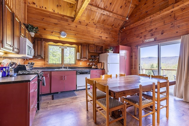 31 Highland View Rd, Weston, VT 05161 - kitchen featuring white appliances, dark countertops, light wood-style flooring, a sink, and wooden walls
