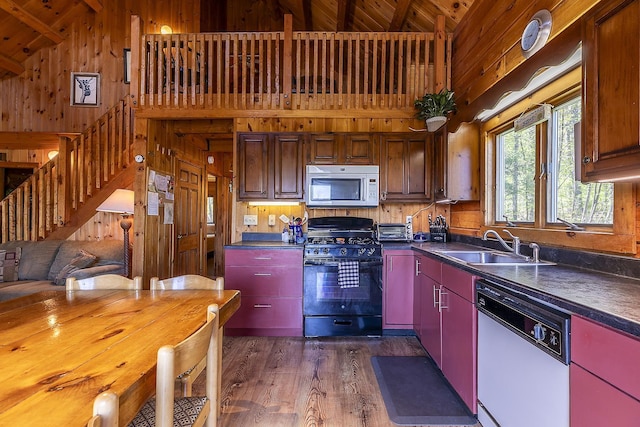 31 Highland View Rd, Weston, VT 05161 - kitchen with white appliances, wood walls, dark countertops, a sink, and dark wood-type flooring