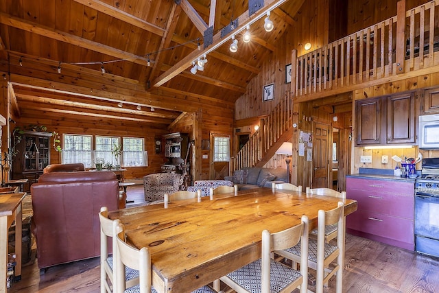 31 Highland View Rd, Weston, VT 05161 - dining area with wood walls, wooden ceiling with exposed beams, track lighting, stairs, and light wood-type flooring