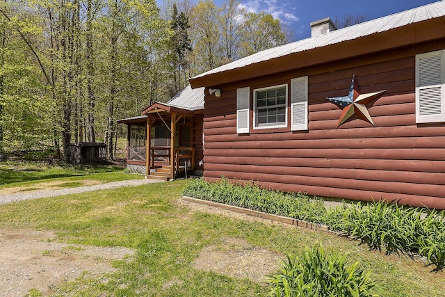 31 Highland View Rd, Weston, VT 05161 - view of home's exterior featuring metal roof, a yard, and faux log siding