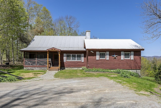 31 Highland View Rd, Weston, VT 05161 - view of front of house featuring covered porch, a chimney, metal roof, and log veneer siding