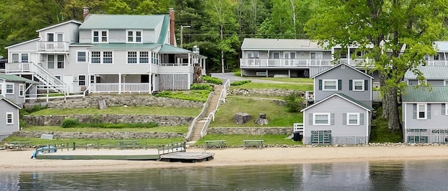 1144 Weirs Blvd Unit 20, Laconia, NH 03246 - back of property with a water view, a chimney, and metal roof