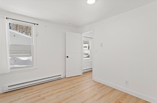 70 Broadway Dr, Amherst, NH 03031 - unfurnished room with baseboard heating, light wood-style floors, and baseboards