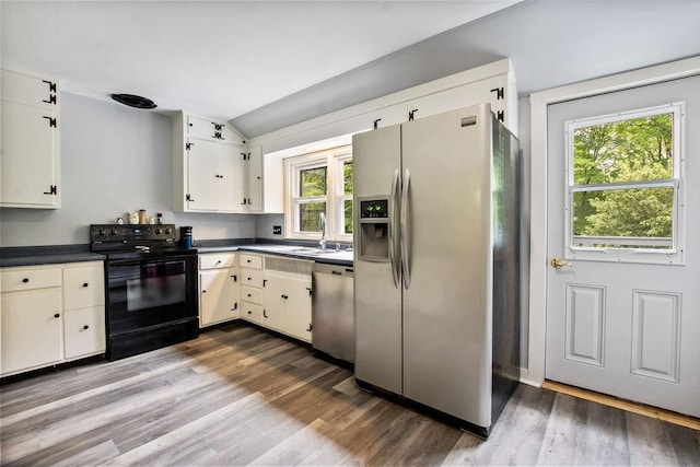 47 Dell Rd, Springfield, VT 05156 - kitchen with stainless steel appliances, a sink, dark countertops, vaulted ceiling, and dark wood finished floors