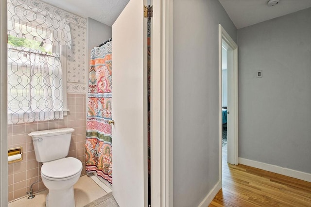 47 Dell Rd, Springfield, VT 05156 - full bathroom featuring toilet, wood finished floors, tile walls, and a shower with curtain