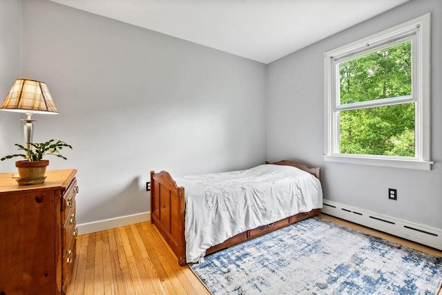 47 Dell Rd, Springfield, VT 05156 - bedroom with multiple windows, light wood finished floors, baseboards, and baseboard heating