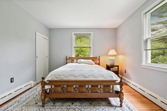 47 Dell Rd, Springfield, VT 05156 - bedroom featuring baseboard heating, multiple windows, and light wood finished floors