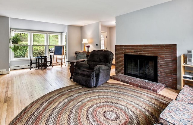 47 Dell Rd, Springfield, VT 05156 - living room with wood-type flooring, a baseboard heating unit, and a fireplace