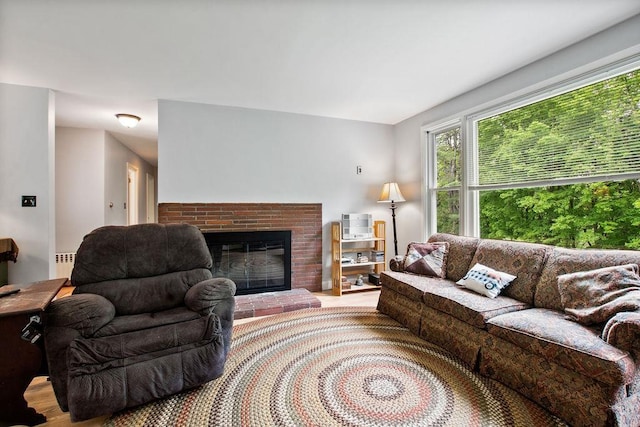 47 Dell Rd, Springfield, VT 05156 - living room with wood finished floors, a brick fireplace, and radiator heating unit