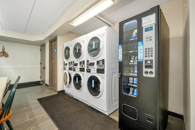 375 Endicott N St Unit 103, Laconia, NH 03246 - shared laundry with stacked washer and clothes dryer, a wainscoted wall, and independent washer and dryer
