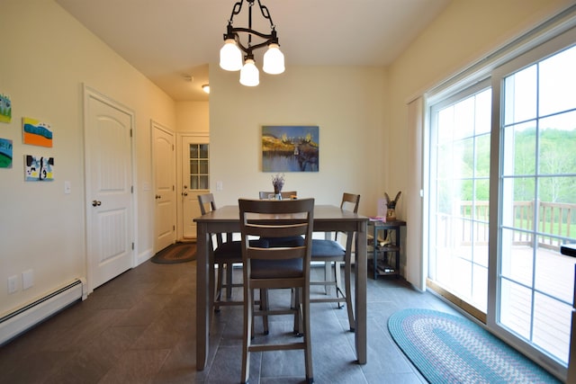 190 Ryans Way, Fletcher, VT 05448 - dining room with a baseboard heating unit, a chandelier, and dark tile patterned flooring