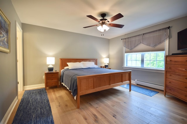 190 Ryans Way, Fletcher, VT 05448 - bedroom with a baseboard heating unit, light wood finished floors, baseboards, and a ceiling fan