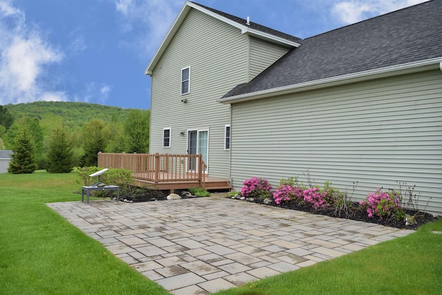 190 Ryans Way, Fletcher, VT 05448 - rear view of house with a patio, a lawn, a deck, roof with shingles, and a wooded view