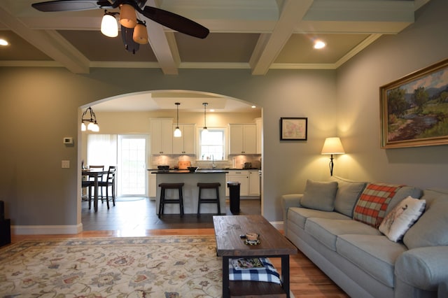 190 Ryans Way, Fletcher, VT 05448 - living area with arched walkways, coffered ceiling, ceiling fan, dark wood-style flooring, and beam ceiling