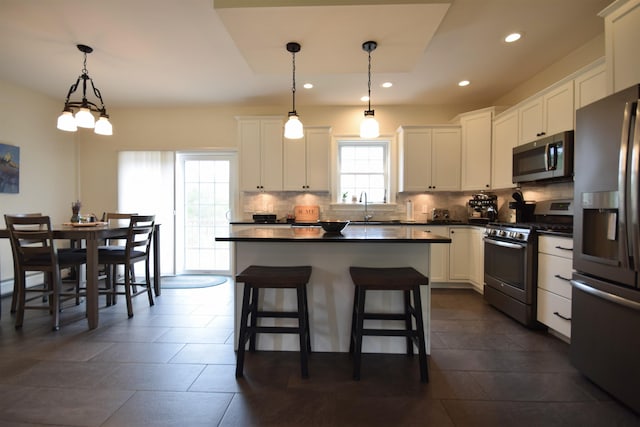 190 Ryans Way, Fletcher, VT 05448 - kitchen featuring stainless steel appliances, dark countertops, decorative backsplash, white cabinetry, and recessed lighting
