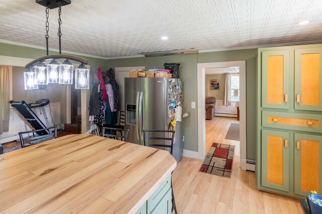 95 Main St, Wells River, VT 05081 - kitchen featuring stainless steel refrigerator with ice dispenser, a baseboard heating unit, light wood finished floors, green cabinets, and an ornate ceiling