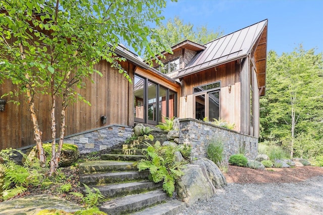 249 Falls Brook Ln, Stowe, VT 05672 - view of front of property featuring a standing seam roof, metal roof, and stone siding