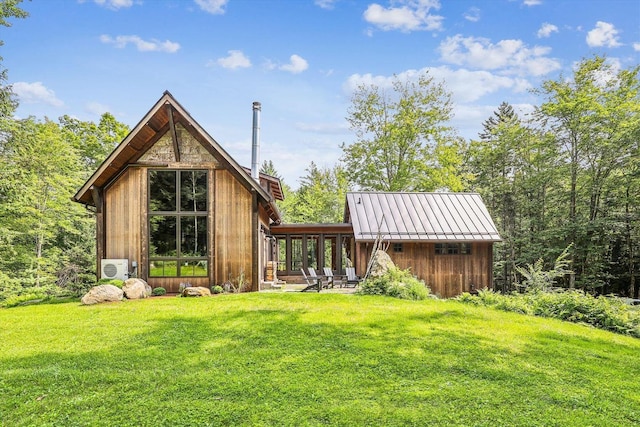 249 Falls Brook Ln, Stowe, VT 05672 - rear view of house featuring a yard and a sunroom