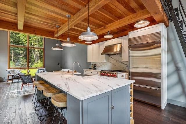 249 Falls Brook Ln, Stowe, VT 05672 - kitchen featuring range hood, stainless steel built in refrigerator, wood ceiling with exposed beams, a sink, and light stone counters