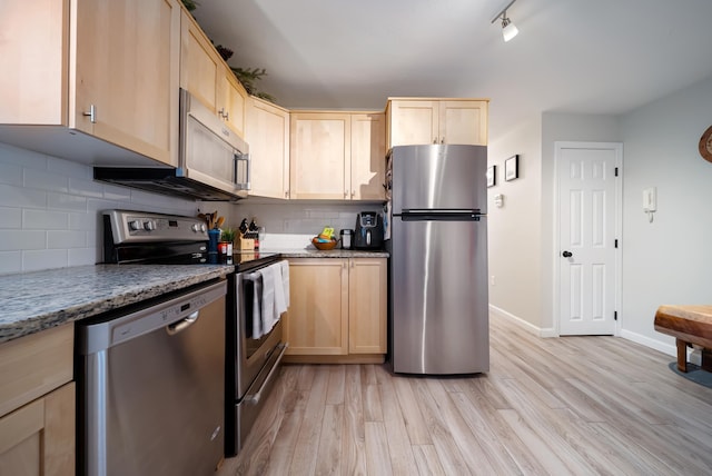 205 Circle Rd Unit 2, Manchester, NH 03103 - kitchen with stainless steel appliances, light brown cabinets, light wood finished floors, backsplash, and baseboards