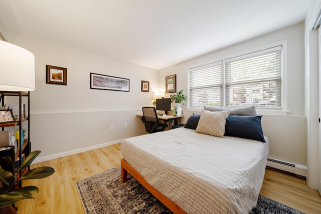205 Circle Rd Unit 2, Manchester, NH 03103 - bedroom featuring wood finished floors, a baseboard heating unit, an office area, and baseboards