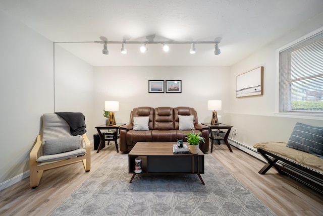 205 Circle Rd Unit 2, Manchester, NH 03103 - living room featuring wood finished floors, rail lighting, and baseboards