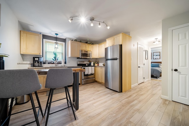 205 Circle Rd Unit 2, Manchester, NH 03103 - kitchen with stainless steel appliances, light brown cabinets, and light wood finished floors