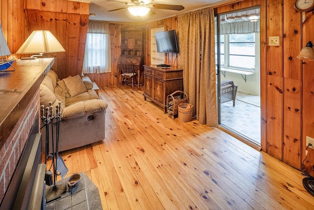 22 Kingsbury Dr, Milton, NH 03851 - living area with light wood-style floors, wood walls, and a ceiling fan