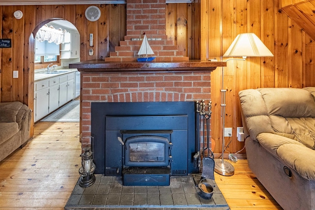 22 Kingsbury Dr, Milton, NH 03851 - living room with wood-type flooring, wooden walls, and a wood stove