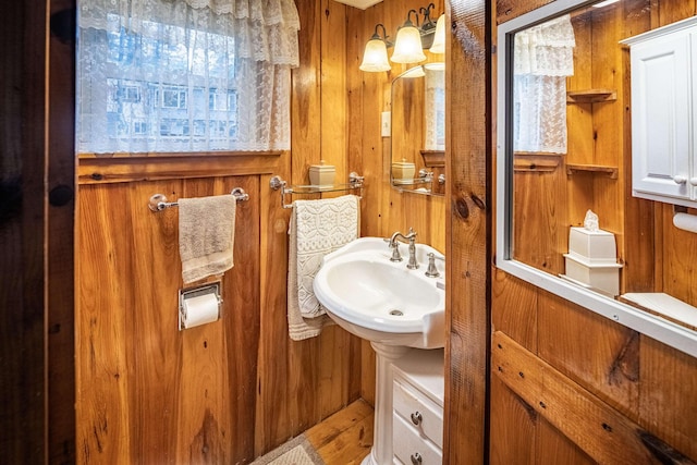 22 Kingsbury Dr, Milton, NH 03851 - bathroom with a sink, wooden walls, and wood finished floors