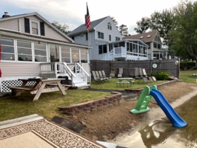 22 Kingsbury Dr, Milton, NH 03851 - rear view of house featuring a sunroom and a playground