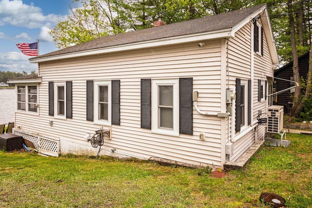 22 Kingsbury Dr, Milton, NH 03851 - view of side of property with a lawn and a shingled roof