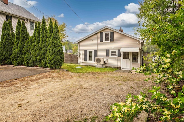 22 Kingsbury Dr, Milton, NH 03851 - back of property with ac unit, a chimney, and entry steps
