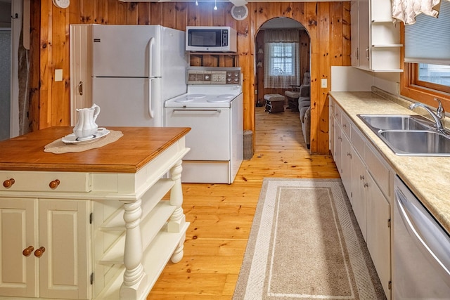 22 Kingsbury Dr, Milton, NH 03851 - kitchen featuring open shelves, stainless steel appliances, wood walls, a sink, and light wood finished floors