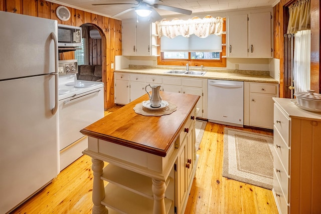 22 Kingsbury Dr, Milton, NH 03851 - kitchen with white appliances, open shelves, a sink, light wood-style flooring, and wood walls