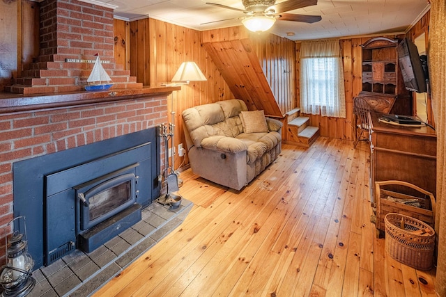22 Kingsbury Dr, Milton, NH 03851 - living area with wood walls, light wood finished floors, crown molding, and a ceiling fan