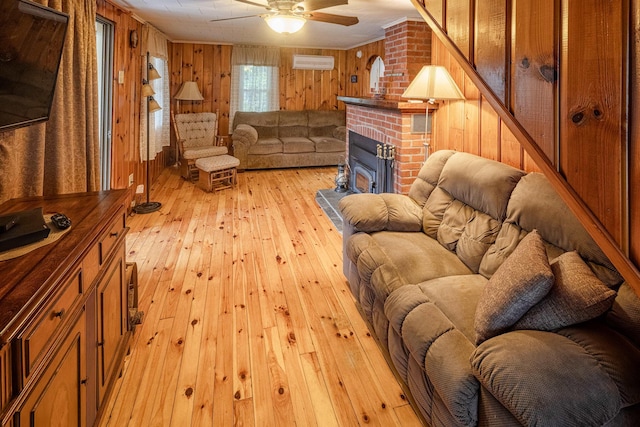 22 Kingsbury Dr, Milton, NH 03851 - living room featuring light wood finished floors, wood walls, a wall unit AC, a ceiling fan, and a fireplace
