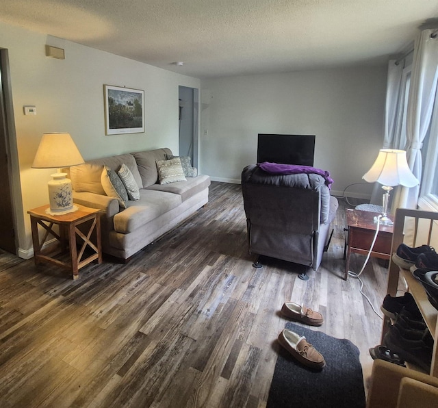 16 Oakwood Dr Unit 16, Claremont, NH 03743 - living area with wood finished floors, a textured ceiling, and baseboards