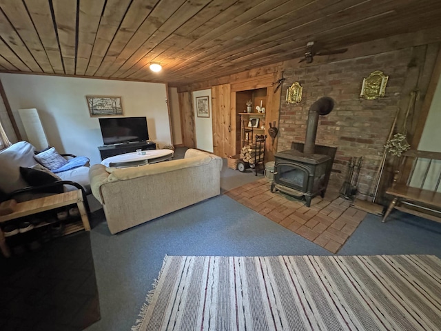 32 Christie Ln, Brattleboro, VT 05301 - carpeted living area featuring a wood stove and wood ceiling