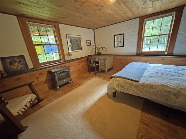 32 Christie Ln, Brattleboro, VT 05301 - bedroom with wooden walls, a wood stove, and wood ceiling