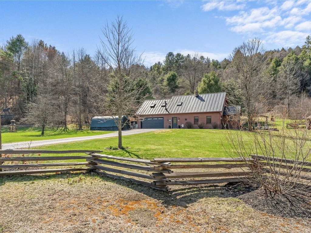 100 Plateau Rd, Calais, VT 05650 - view of front of property featuring dirt driveway, an attached garage, and a wooded view