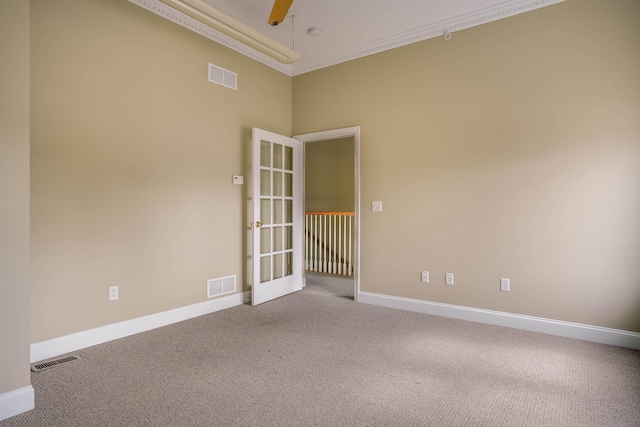 21 E Pearl St, Nashua, NH 03060 - empty room with carpet floors, french doors, baseboards, a smoke detector, and crown molding