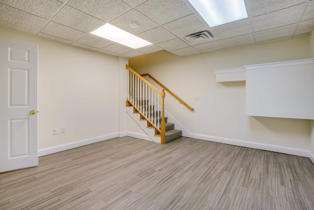 21 E Pearl St, Nashua, NH 03060 - basement featuring baseboards, wood finished floors, stairs, and a drop ceiling