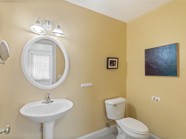 8 Checkerberry Sq Unit 106, Milton, VT 05468 - half bathroom with baseboards, toilet, and tile patterned flooring