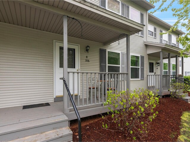 8 Checkerberry Sq Unit 106, Milton, VT 05468 - doorway to property featuring a porch