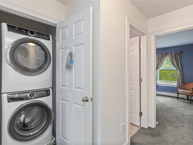 8 Checkerberry Sq Unit 106, Milton, VT 05468 - laundry room with stacked washer / drying machine, carpet floors, baseboard heating, and baseboards